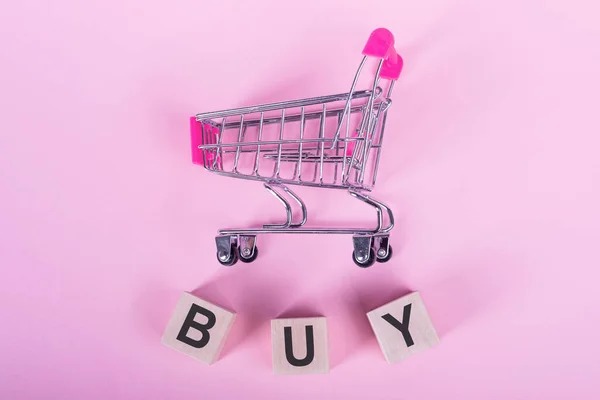 Buy Word Wooden Cubes Pink Background Shopping Trolley — Zdjęcie stockowe