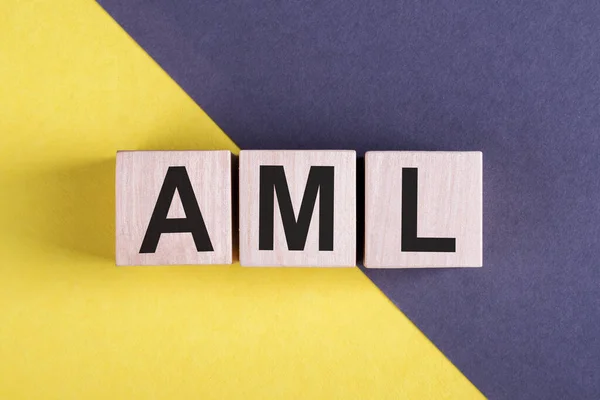 Word Aml Money Laundering Wooden Cubes Yellow Blue Background — Stock Photo, Image