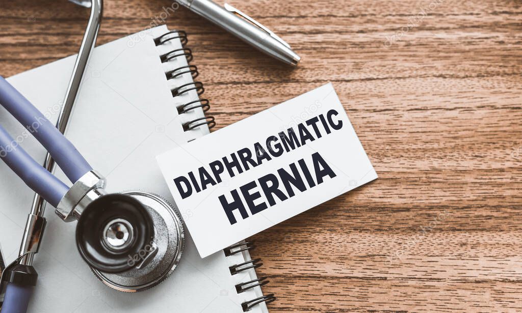 A card with text Diaphragmatic hernia on wooden doctor's table