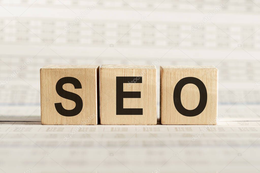 SEO abbreviation - search engine optimization, on wooden cubes on a light background.