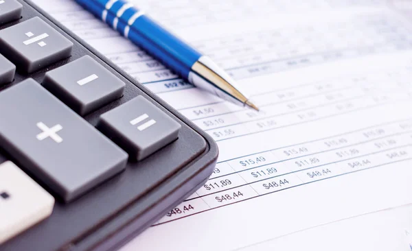 Financial accounting Pen and calculator on balance sheets