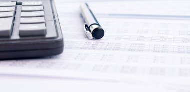 Calculator, pen and financial statement, financial background