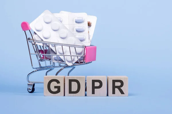 Word Gdpr Wooden Cubes Blue Background Pills Shopping Trolley — Stock Photo, Image