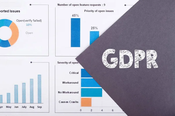 The word GDPR - General Data Protection Regulation, is written on a gray background with diagrams and graphs.