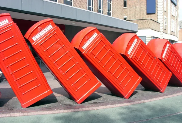 Traditional old style red phone boxes in London - domino effect — Stock Photo, Image