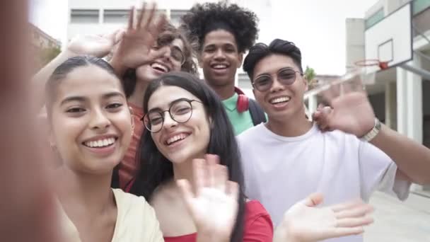 Ομάδα από πολυφυλετικούς έφηβους φίλους που μιλούν selfie με το τηλέφωνο κοιτάζοντας την κάμερα. Ευτυχισμένοι πολυεθνικοί μαθητές στο Γυμνάσιο — Αρχείο Βίντεο