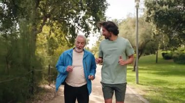 Happy senior father and son jogging doing sport together, running for healthy lifestyle and family bonding