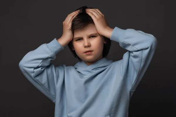 ストレスの少年10から12歳のイメージは カジュアルな服を彼の頭をつかむに身を包んだ 感情的な無力感 恐怖の概念 スタジオ撮影 グレーの背景 — ストック写真