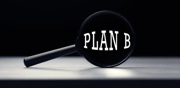 stock image Magnifying glass with the word plan b on table. Search idea