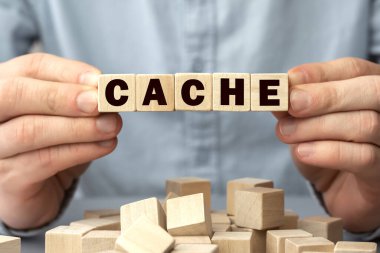 CACHE kelimesi ahşap küplerden yapılmıştır. Kavramsal fotoğraf. Seçici odaklanma. Küplerdeki yüzeysel alan derinliği