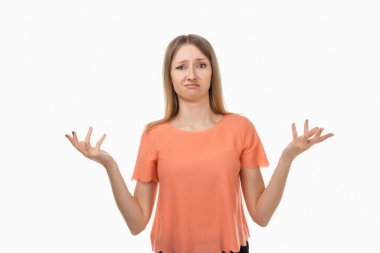 Bilmiyorum, bu ben değilim. Kafası karışmış, kafası karışmış, elleri yana yana açık omuz silkmiş, kararsız sarışın bir kızın portresi. Stüdyo çekimi, beyaz arkaplan