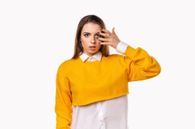 Endişeli, korkmuş esmer kız, ağzı açık bir şekilde el ele tutuşuyor. Heyecan verici bir şey duyuyorum. Beyaz arka plan.