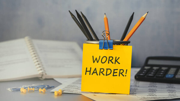 Work Harder - concept of text on sticky note. Closeup of a personal agenda