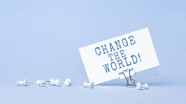 Change the world - concept of text on business card. Closeup of a personal agenda
