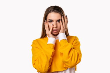 Endişeli, korkmuş esmer kız ağzını açıp el ele tutuşurken heyecan verici bir şey duydum. Beyaz arka plan.