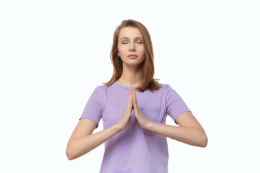 Çekici kız ailenin iyiliği için dua ediyor, dua ederken avuçlarını birbirine bastırıp namaste diyor. İnsani duygular, jest kavramı. Stüdyo çekim teli arkaplanı