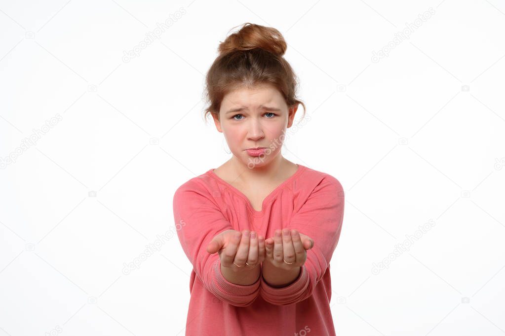compassionate teen girl isolated on white background asks for help, gestures with hands, reaching hands of hand to the camera