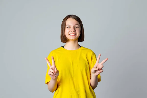 Улыбающаяся Весёлая Девочка Подросток Показывает Двойной Знак Знак Мира Стоит — стоковое фото