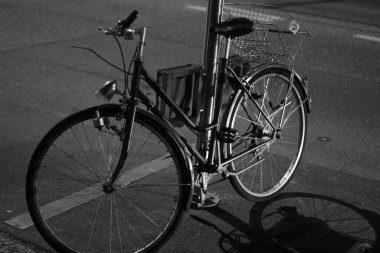 Yol kenarında eski bir bisiklet. Siyah beyaz fotoğraf.