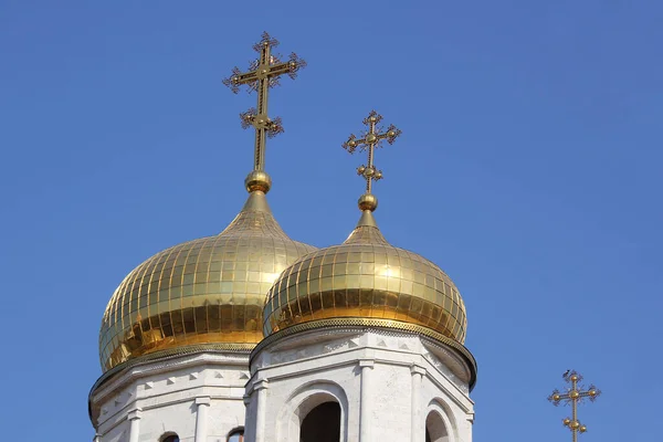 Golden church domes against the blue sky.