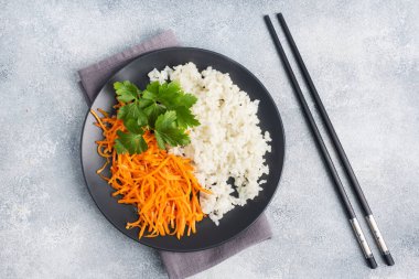 Beyaz haşlanmış pirinç ve baharatlı Kore havuç salatası.