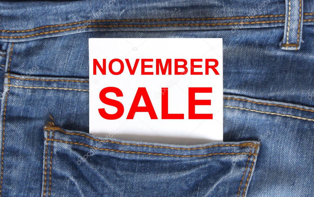 Text November Sale on white paper in the pocket of blue denim jeans. Can be use as marketing concept