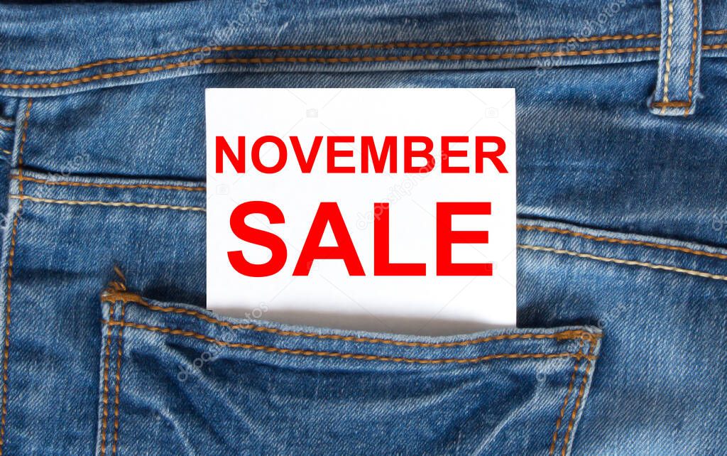Text November Sale on white paper in the pocket of blue denim jeans. Can be use as marketing concept