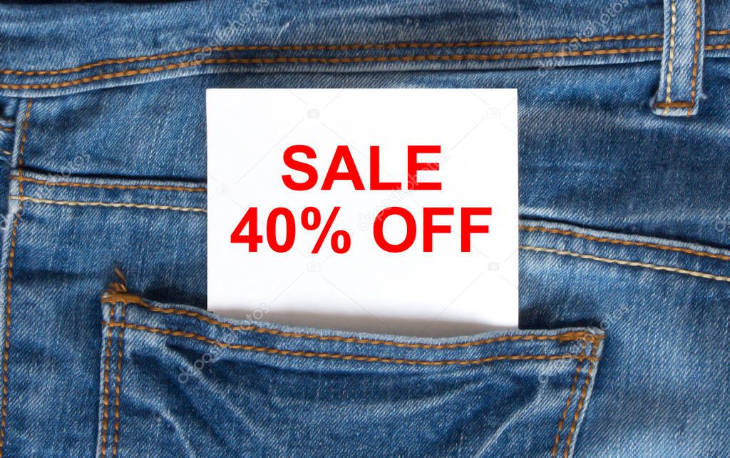 Text Sale 40 off on white paper in the pocket of blue denim jeans. Can be use as marketing concept