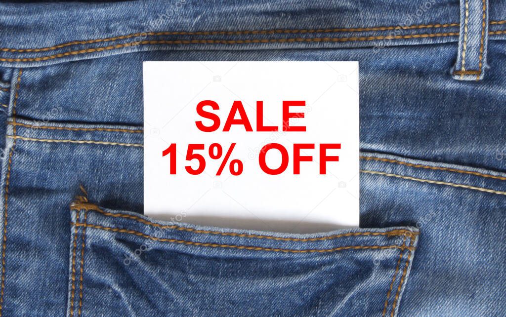 Text Sale 15 off on white paper in the pocket of blue denim jeans. Can be use as marketing concept