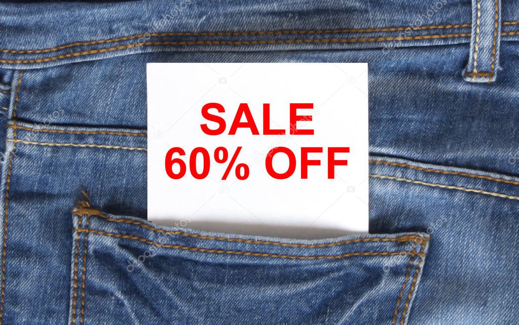 Text Sale 60 off on white paper in the pocket of blue denim jeans. Can be use as marketing concept