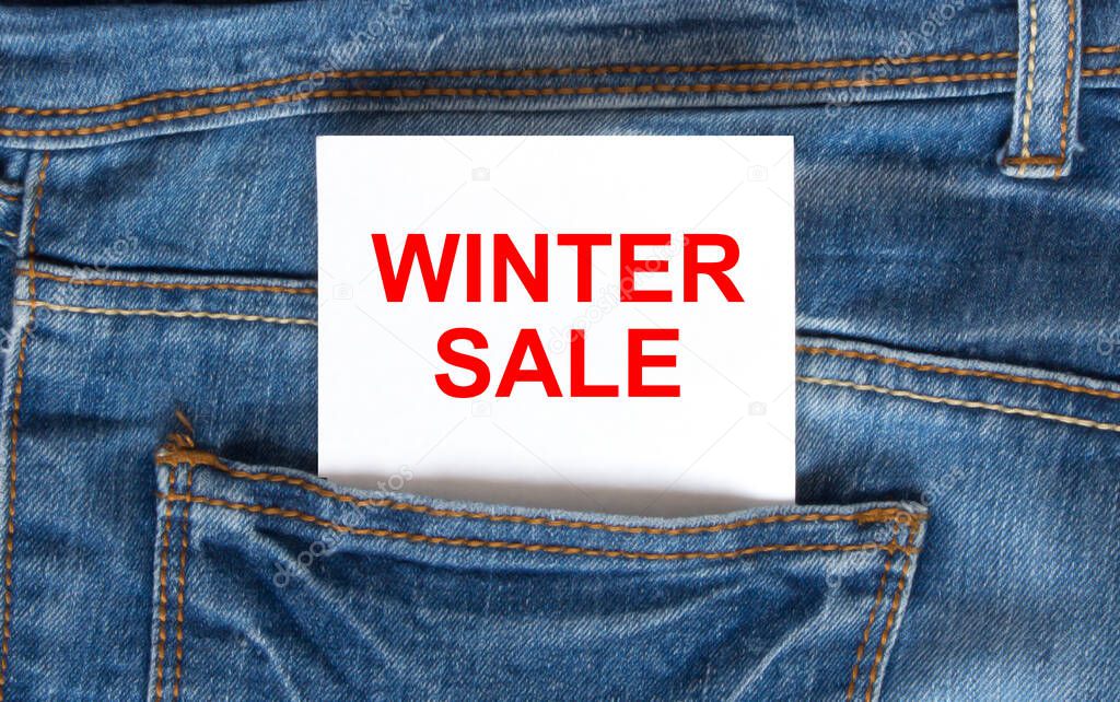 Text Winter Sale on white paper in the pocket of blue denim jeans. Can be use as marketing concept