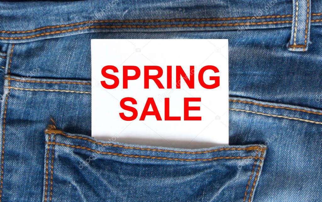 Text Spring Sale on white paper in the pocket of blue denim jeans. Can be use as marketing concept