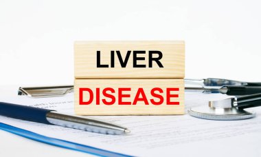 Pano, steteskop ve kalemle karaciğer hastalığının yazılı olduğu tahta bloklar. Tıbbi konsept