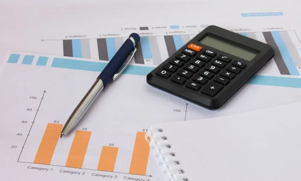 Profit bar chart, pen, notepad and calculator. Financial and business concept