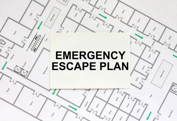 Business card with text Emergency Escape Plan on a construction drawing. Concept photo