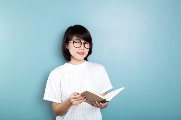 Young asian women thinking on blue background.