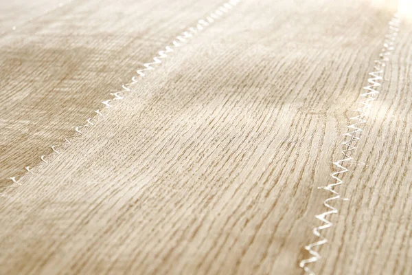 Oak texture as background. Spliced oak veneer with glue thread for furniture manufacturing closeup