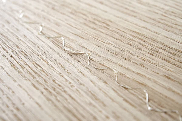 Oak texture as background. Spliced oak veneer with glue thread for furniture manufacturing closeup