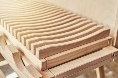 Modern marangozluk atölyesinde kontrplak dolabının yanında, hafif ahşap ahşap ahşap kerestelerden yapılmış şık tabaklar.