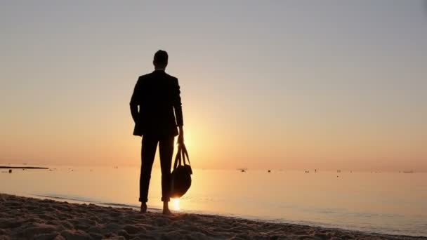 Man Suit Carry Travel Bag Stands Barefoot Seashore Early Morning — Stock Video