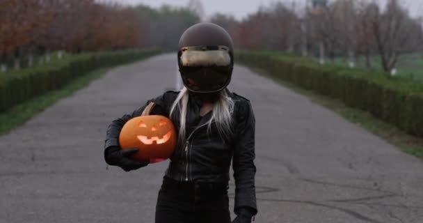 Woman Black Leather Suit Protective Biker Helmet Walks Road Carries — Stock Video