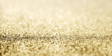 Soyut altın parıltısı arkaplan ile bulanıklaştırılmış