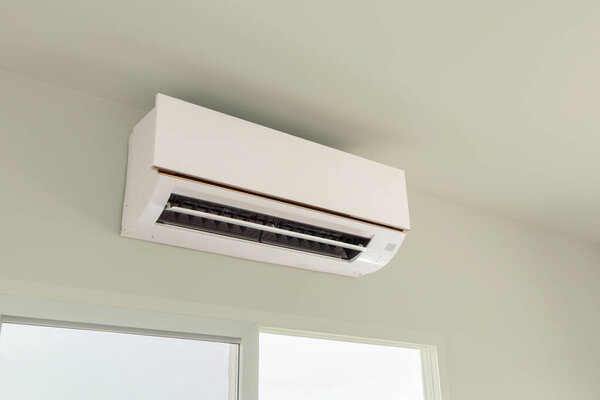 Air conditioner on white wall room interior background