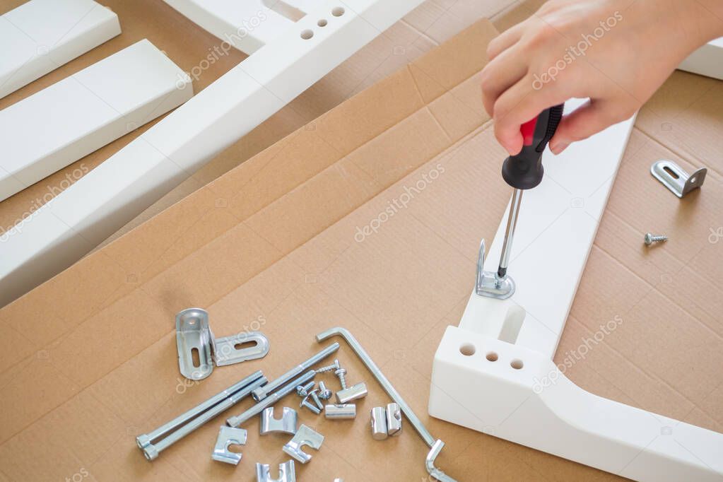 Assembly furniture using screwdriver at home