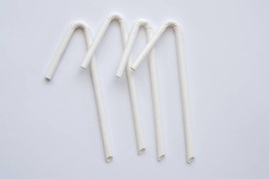 Biyo-çözünebilir çevre dostu beyaz kağıt beyaz arka planda saman içiyor