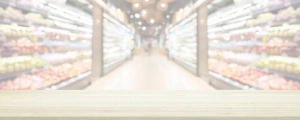 Wood table top with supermarket grocery store blurred background with bokeh light for product display