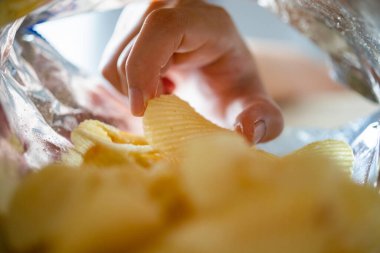 Atıştırmalık çantanın içinde patates cipsi topluyorum.