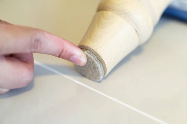 Woman Sticking Floor Care Pad Sofa Leg — Stock Photo, Image