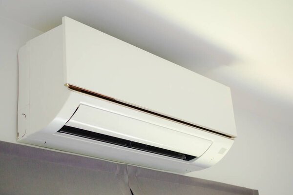 Air conditioner on white wall room interior background