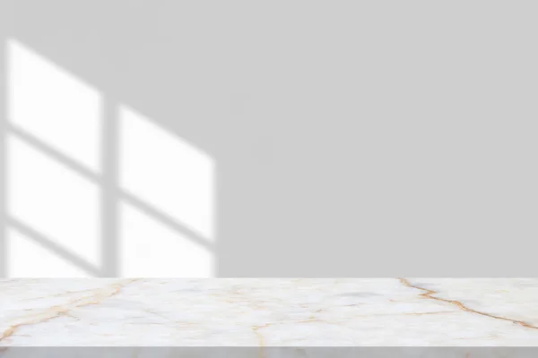 Marble table with window shadow drop on white wall background for mockup product display